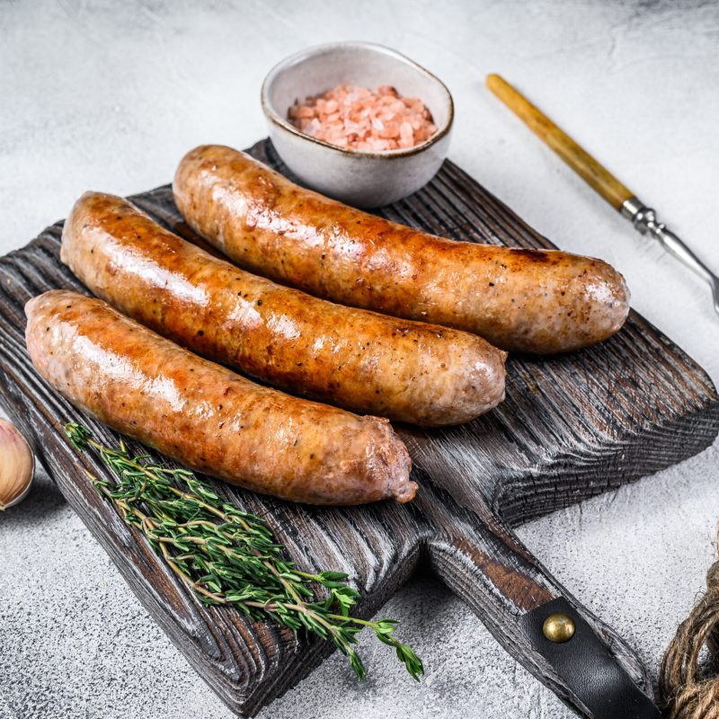 Sausages,Barbecue,Fried,With,Spices,And,Herbs,On,A,Wooden